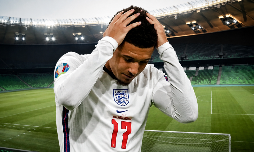 Jadon Sancho wearing number 17, hands on his head in a near-empty stadium