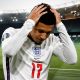 Jadon Sancho wearing number 17, hands on his head in a near-empty stadium